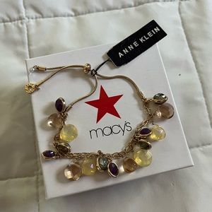 Beautiful gold and purple Anne Klein adjustable bracelet with charms